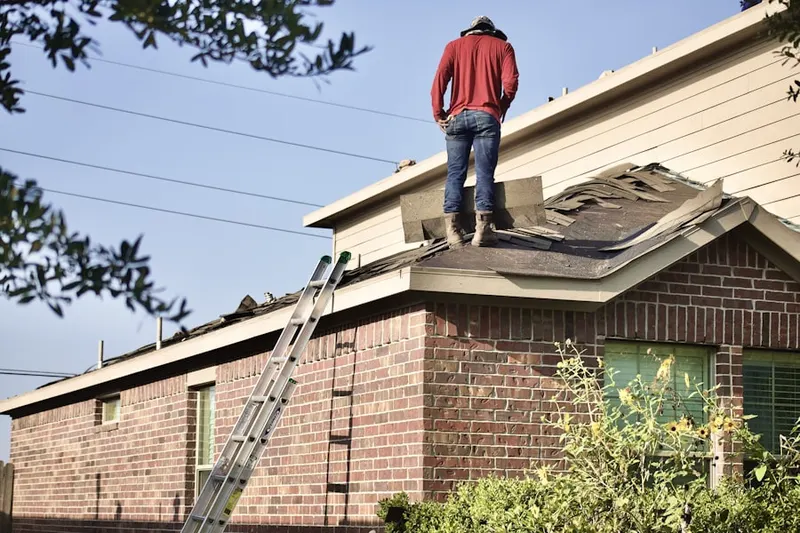 Professional roofer working on a residential roof in Sylvan Lane